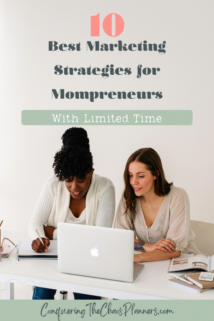 Two mompreneurs collaborating at a table, one taking notes while the other looks at a laptop. Text overlay reads: '10 Best Marketing Strategies for Mompreneurs with Limited Time'. Website URL at the bottom: ConqueringTheChaosPlanners.com